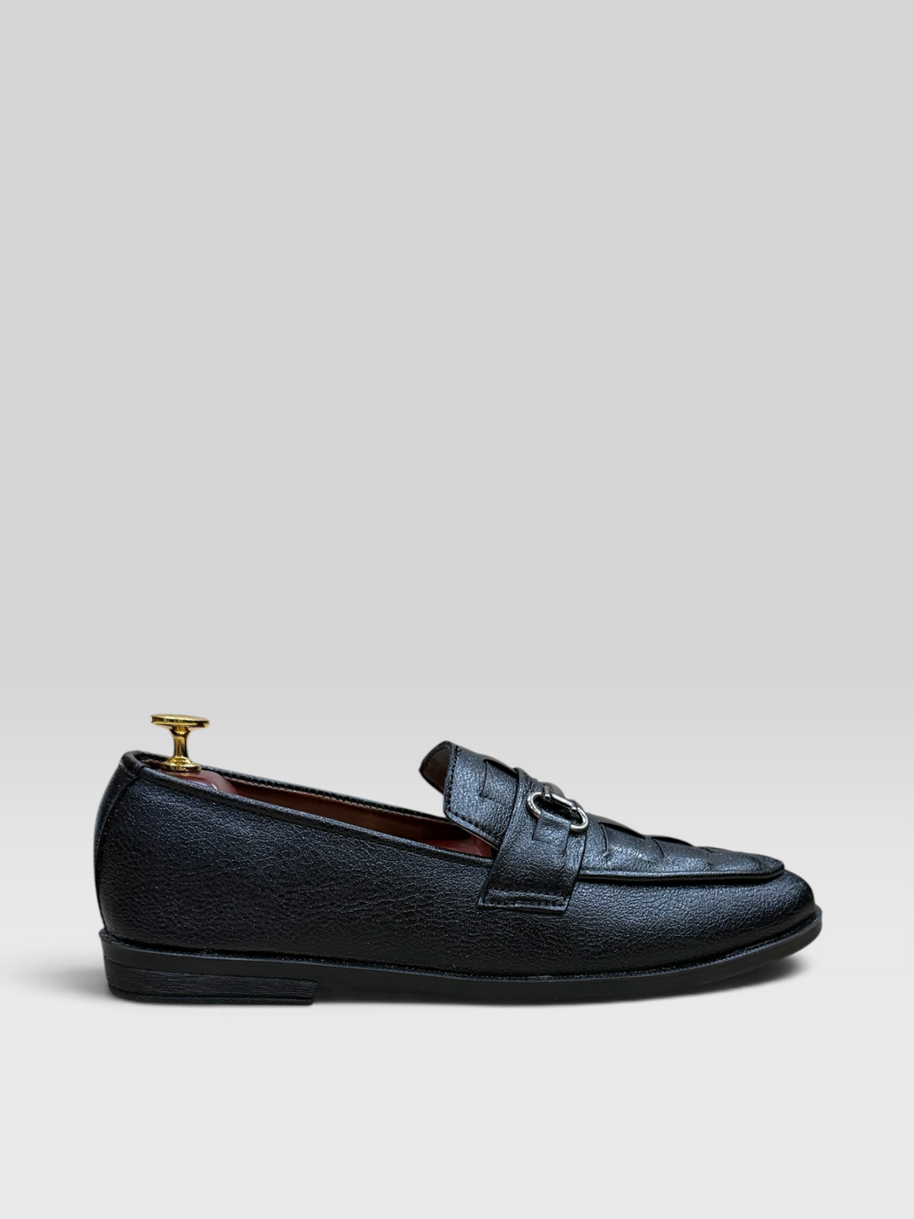 VELORO black textured formal loafers for men with silver horsebit detail and red interior lining, side view.