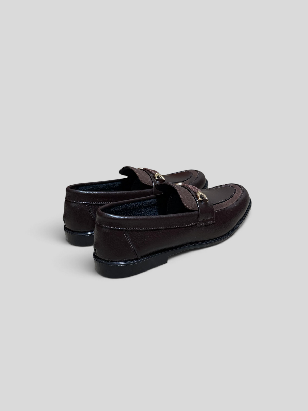 VELORO dark brown formal loafers with textured leather finish and gold-toned metal hardware detail on the vamp.